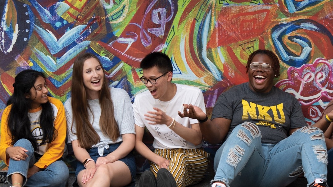 Diverse students laughing together in a group